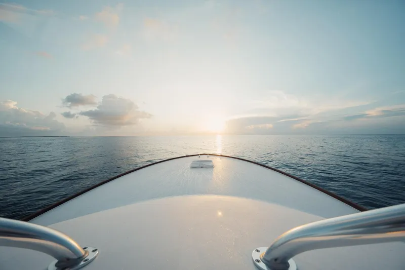 Dog House Yacht Photos Pics Bow of 2016 F&S Express boat at sunrise on calm ocean.