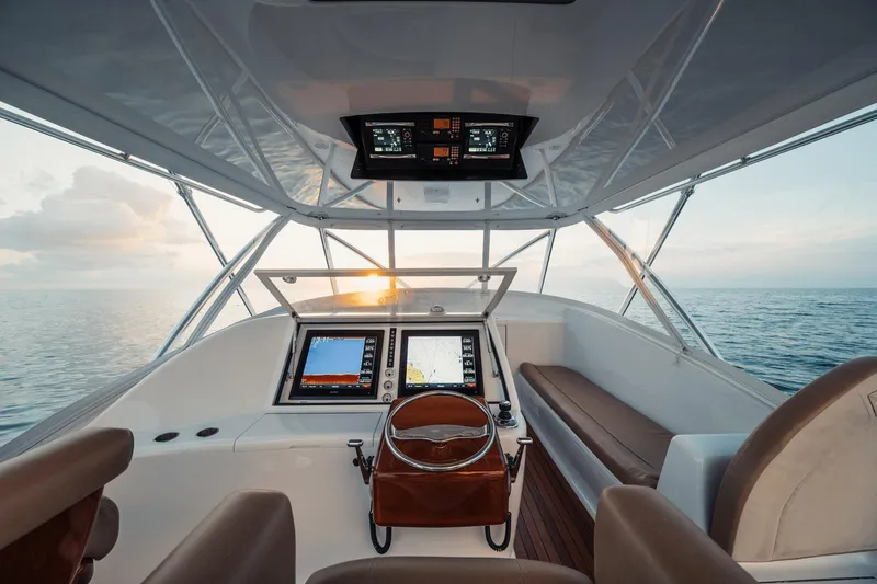 Dog House Yacht Photos Pics Helm of 2016 F&S Express boat with navigation screens, steering wheel, and ocean view.