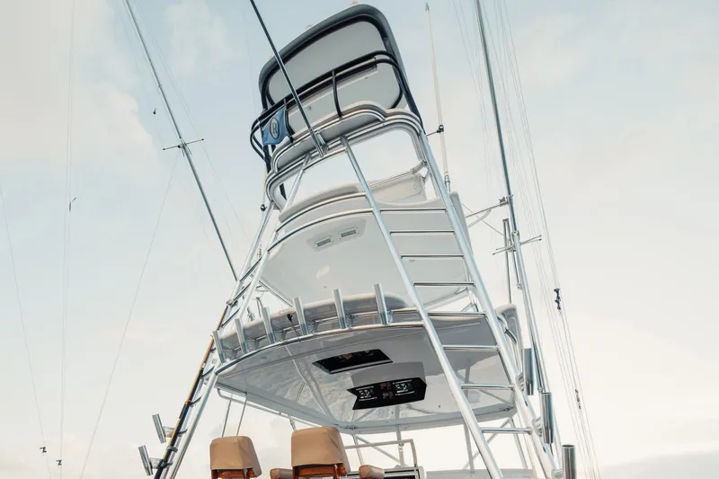 Dog House Yacht Photos Pics 2016 F&S Express yacht tower with ladder and equipment against a clear sky.