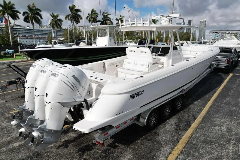  Yacht Photos Pics 2022 Intrepid 345 Nomad FE boat with triple outboard engines on a trailer.