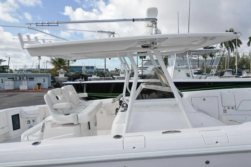  Yacht Photos Pics 2022 Intrepid 345 Nomad FE boat with sleek white seating and canopy.