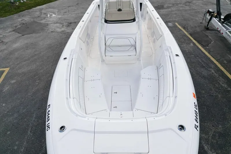  Yacht Photos Pics 2022 Intrepid 345 Nomad FE boat, spacious deck view, white interior, parked on pavement.