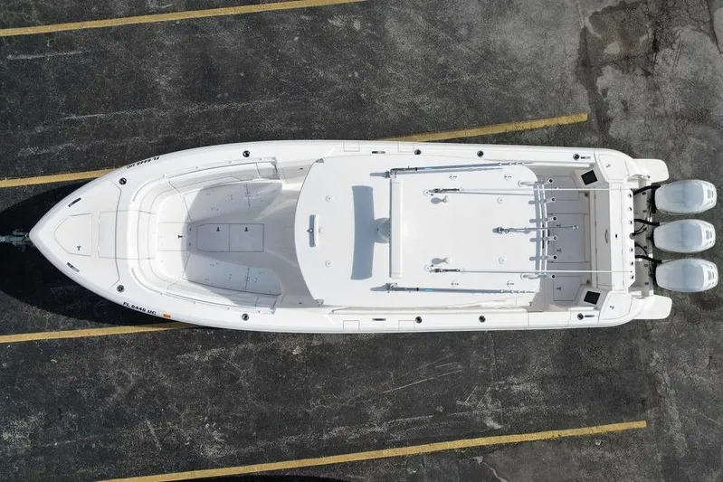  Yacht Photos Pics Overhead view of 2022 Intrepid 345 Nomad FE boat in parking lot.