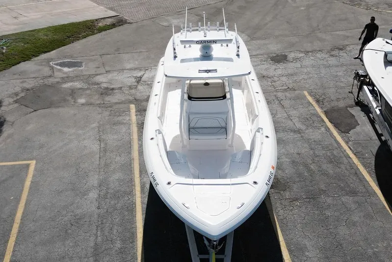  Yacht Photos Pics 2022 Intrepid 345 Nomad FE boat parked on asphalt, aerial view.