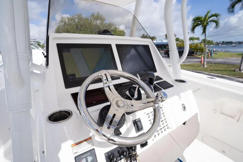  Yacht Photos Pics 2022 Intrepid 345 Nomad FE boat helm with dual displays and steering wheel.