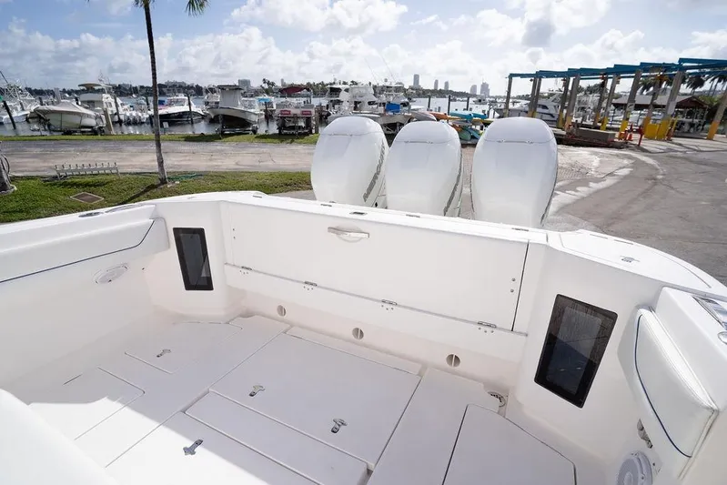  Yacht Photos Pics 2022 Intrepid 345 Nomad FE boat with triple engines docked at marina.
