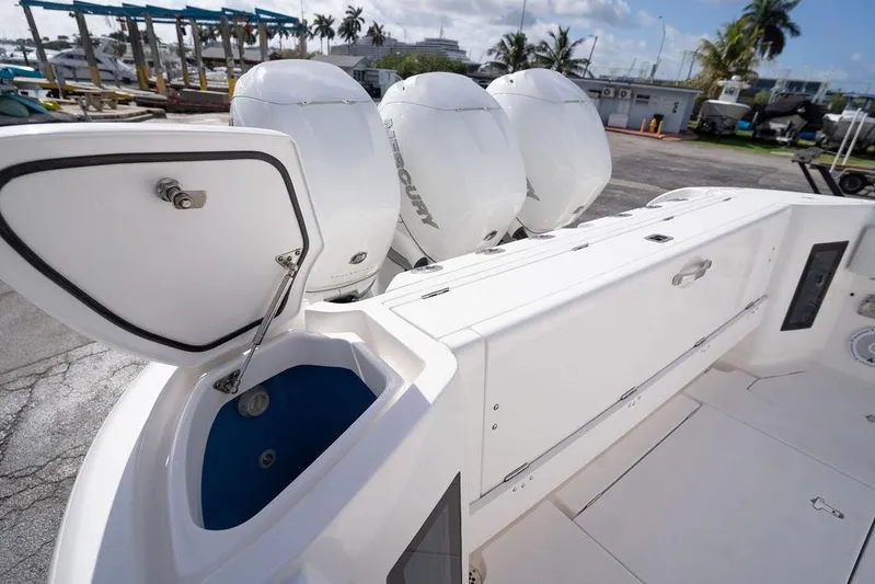  Yacht Photos Pics 2022 Intrepid 345 Nomad FE boat with open storage compartment and powerful Mercury engines.