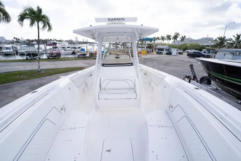  Yacht Photos Pics 2022 Intrepid 345 Nomad FE boat docked at marina, featuring spacious deck and modern design.