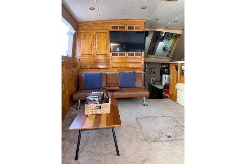 Unbelievable Yacht Photos Pics Interior of 1984 Bertram 42 Convertible yacht with wood cabinetry and modern seating.
