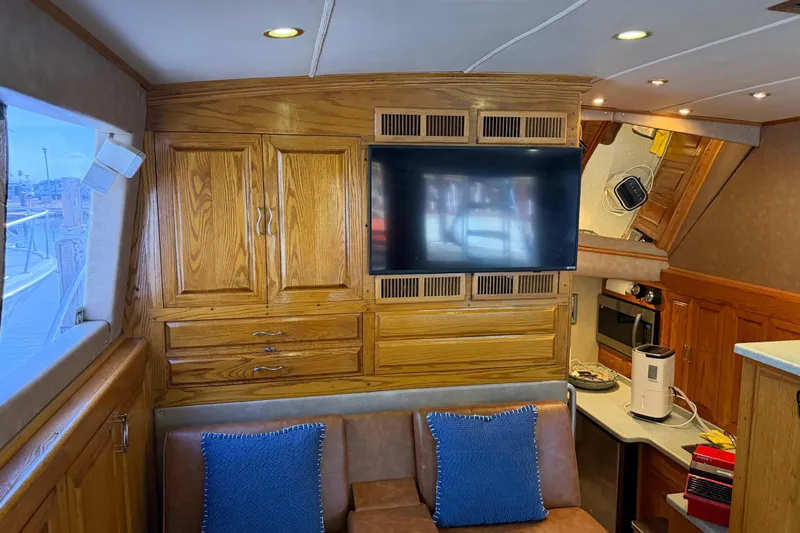 Unbelievable Yacht Photos Pics Interior of 1984 Bertram 42 Convertible yacht with wood cabinetry and modern amenities.