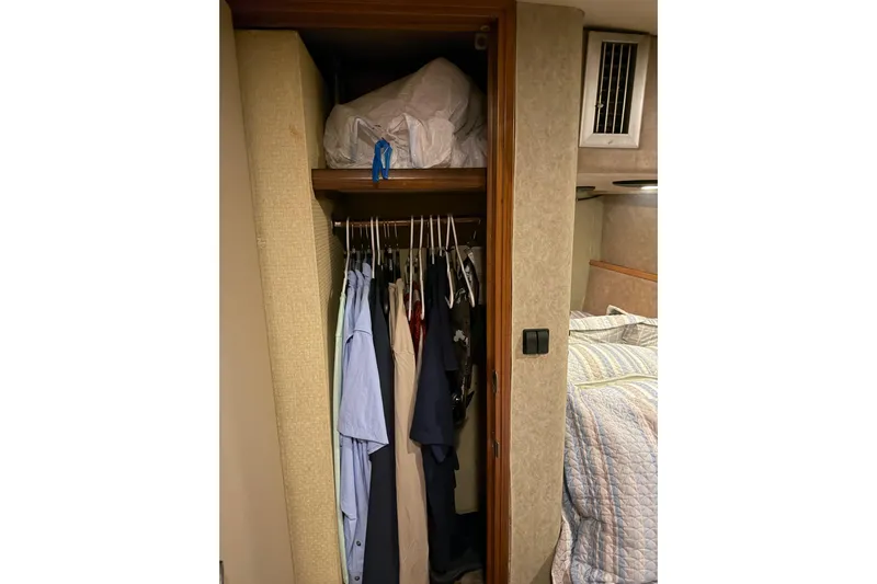 Unbelievable Yacht Photos Pics Closet with clothes in 1984 Bertram 42 Convertible boat interior.