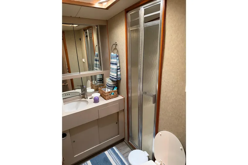 Unbelievable Yacht Photos Pics Bathroom interior of 1984 Bertram 42 Convertible yacht with shower and vanity.