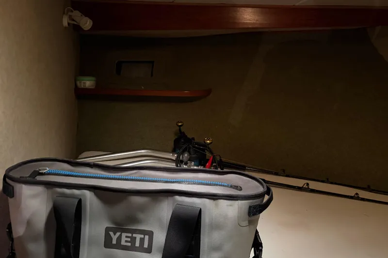 Unbelievable Yacht Photos Pics Interior of 1984 Bertram 42 Convertible with Yeti cooler and fishing rods.