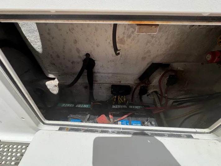  Yacht Photos Pics Battery compartment of a 2019 World Cat 3200 boat, showing wiring and connections.