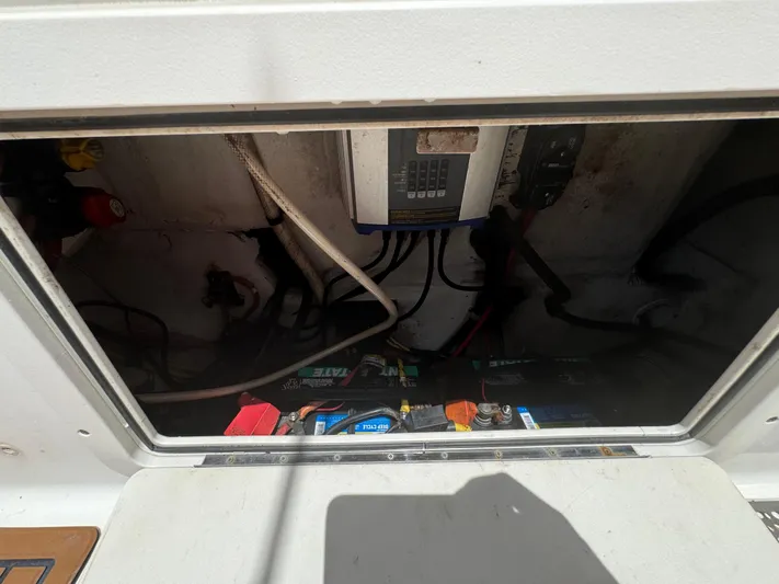  Yacht Photos Pics Electrical compartment of a 2019 World Cat 3200 boat, showing wiring and battery setup.