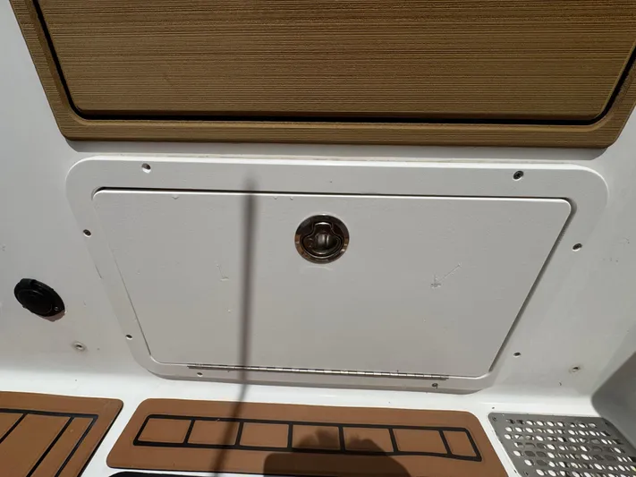  Yacht Photos Pics 2019 World Cat 3200 boat storage compartment with latch and non-slip flooring.