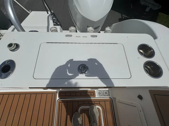  Yacht Photos Pics 2019 World Cat 3200 boat deck with fishing rod holders and storage compartment.