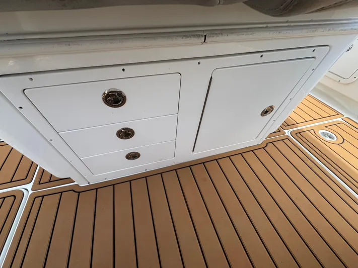 Yacht Photos Pics 2019 World Cat 3200 boat interior with white storage cabinets and teak flooring.