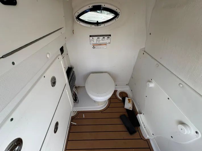  Yacht Photos Pics 2019 World Cat 3200 boat interior with toilet and porthole window.