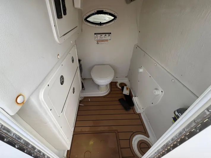  Yacht Photos Pics Interior of 2019 World Cat 3200 boat bathroom with toilet and wooden floor.