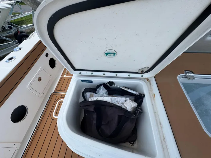  Yacht Photos Pics Open storage compartment on 2019 World Cat 3200 boat with bag inside.
