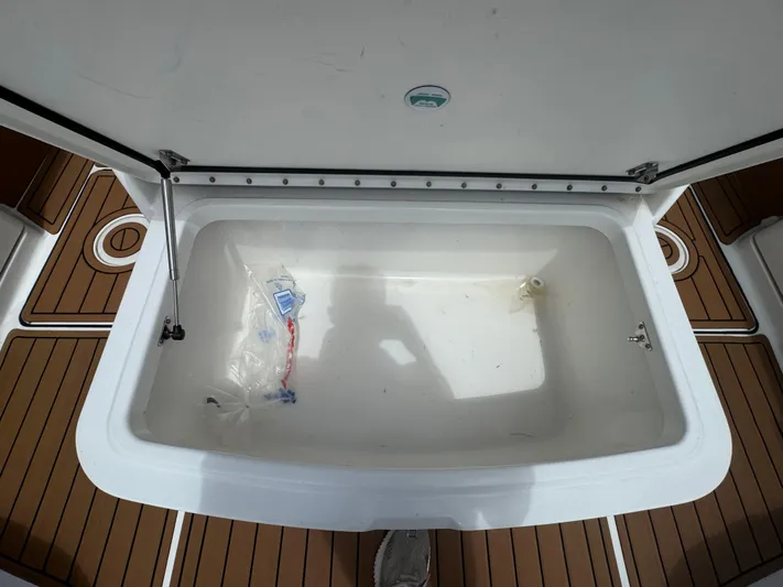  Yacht Photos Pics Open storage compartment on 2019 World Cat 3200 boat with teak flooring.
