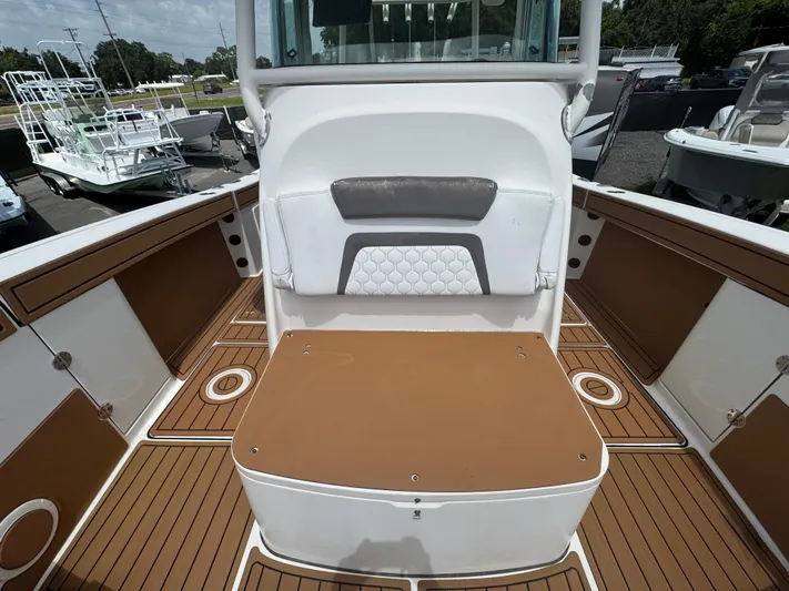  Yacht Photos Pics 2019 World Cat 3200 boat interior with brown and white seating and deck.