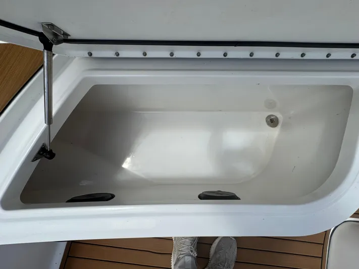  Yacht Photos Pics Open storage compartment on a 2019 World Cat 3200 boat, featuring a clean interior.