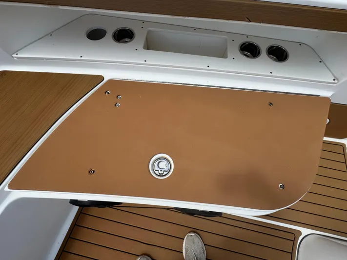  Yacht Photos Pics 2019 World Cat 3200 boat deck with storage compartment and wood finish.