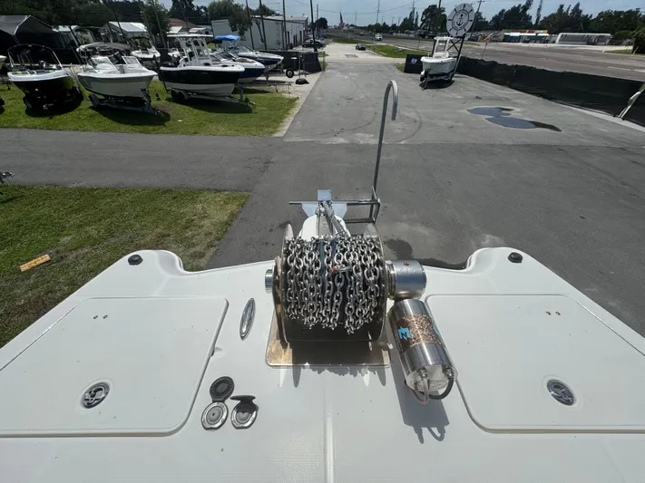  Yacht Photos Pics 2019 World Cat 3200 boat with anchor chain, docked among other boats.