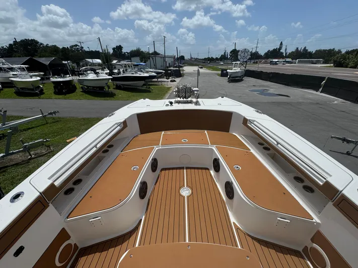  Yacht Photos Pics 2019 World Cat 3200 boat interior with tan deck, docked under a cloudy sky.