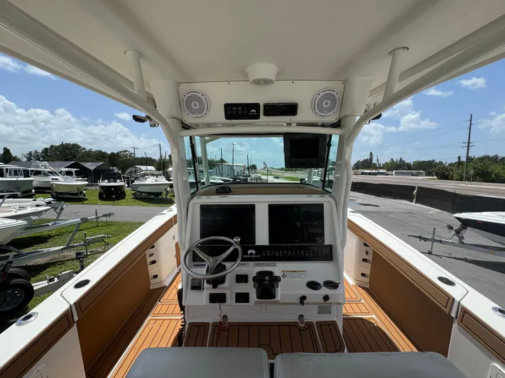  Yacht Photos Pics 2019 World Cat 3200 boat cockpit with steering wheel and control panel.