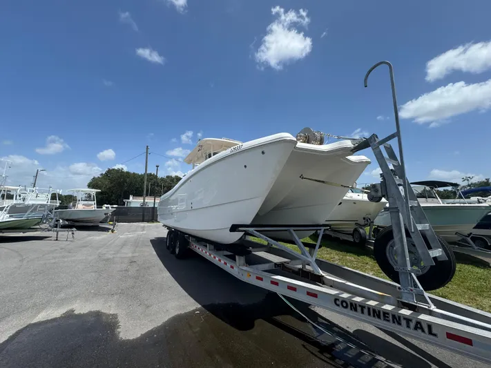  Yacht Photos Pics 2019 World Cat 3200 boat on trailer under clear blue sky.