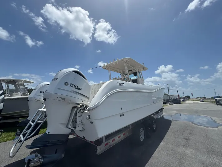  Yacht Photos Pics 2019 World Cat 3200 boat with Yamaha engines on a trailer under a clear blue sky.