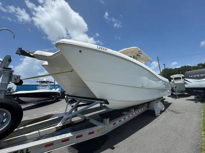  Yacht Photos Pics 2019 World Cat 3200 boat on trailer under clear blue sky.
