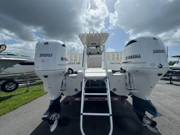  Yacht Photos Pics 2019 World Cat 3200 boat with twin Yamaha 300 engines, parked under cloudy sky.