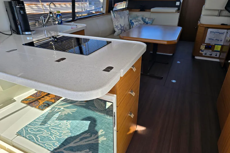  Yacht Photos Pics Modern interior of 2020 Greenline 40 yacht with kitchen and dining area.