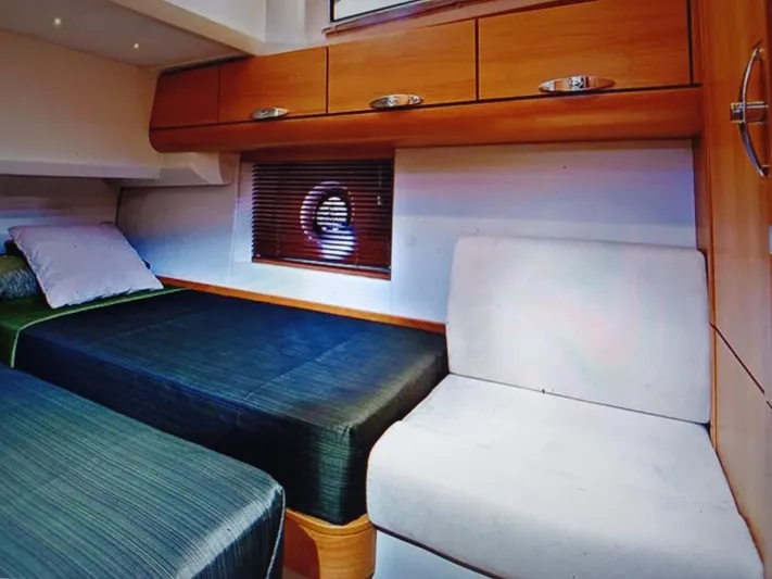  Yacht Photos Pics Interior of 2020 Greenline 40 yacht cabin with twin beds and wooden cabinetry.