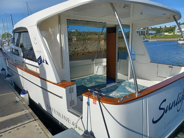  Yacht Photos Pics 2020 Greenline 40 yacht docked at marina, showcasing sleek design and spacious deck.