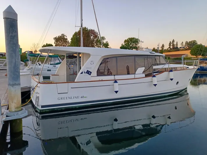  Yacht Photos Pics 2020 Greenline 40 yacht docked at marina, reflecting on calm water.