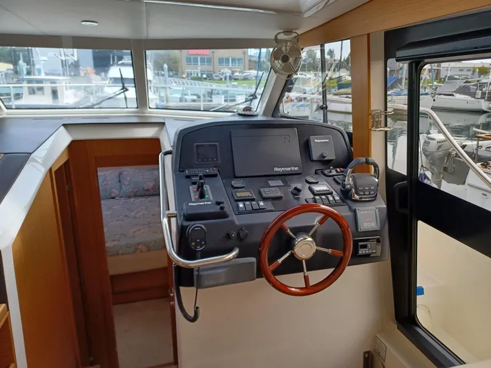  Yacht Photos Pics Helm of 2020 Greenline 40 yacht with navigation equipment and wooden steering wheel.