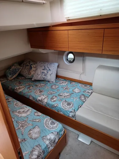  Yacht Photos Pics Cozy cabin interior of 2020 Greenline 40 yacht with nautical-themed bedding.