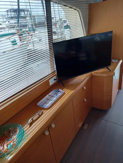  Yacht Photos Pics Interior of 2020 Greenline 40 yacht with TV and wooden cabinetry.