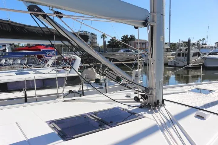 Sea Dawgs Yacht Photos Pics 2021 Beneteau Oceanis Yacht 54 docked, showcasing sleek deck and rigging details.
