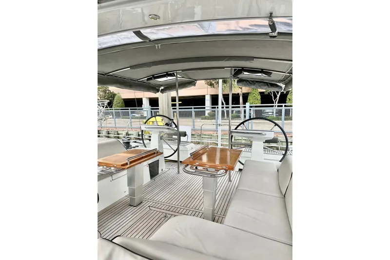 Sea Dawgs Yacht Photos Pics 2021 Beneteau Oceanis Yacht 54 cockpit with dual steering wheels and seating area.