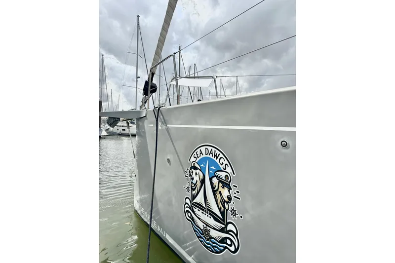 Sea Dawgs Yacht Photos Pics Beneteau Oceanis Yacht 54, 2021, with "Sea Dawgs" logo, docked in a marina.