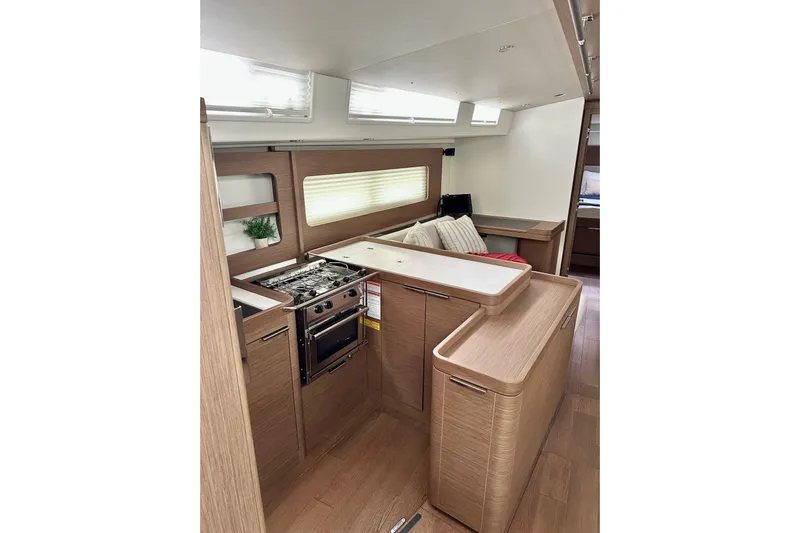 Sea Dawgs Yacht Photos Pics Interior of 2021 Beneteau Oceanis Yacht 54, featuring modern kitchen and seating area.