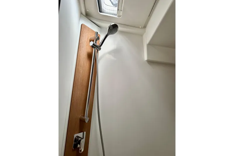 Sea Dawgs Yacht Photos Pics Shower area in 2021 Beneteau Oceanis Yacht 54, featuring modern fixtures and wooden paneling.