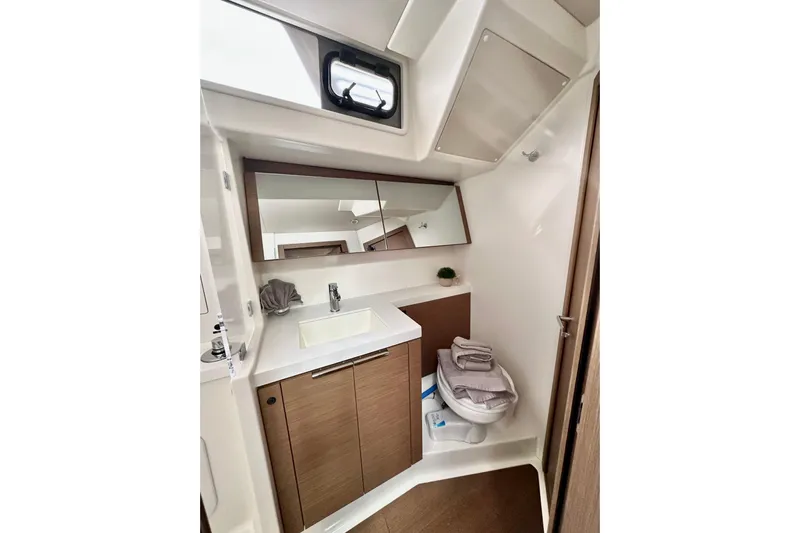 Sea Dawgs Yacht Photos Pics Modern bathroom in 2021 Beneteau Oceanis Yacht 54, featuring sleek design and wood accents.