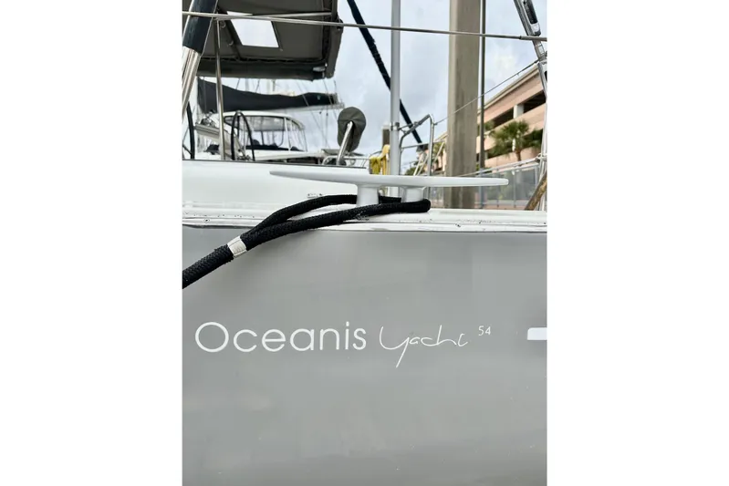 Sea Dawgs Yacht Photos Pics 2021 Beneteau Oceanis Yacht 54, docked with visible branding and mooring line.